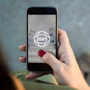 Top view of woman walking in the street surfing 360 degree view in her mobile. All screen graphics are made up.